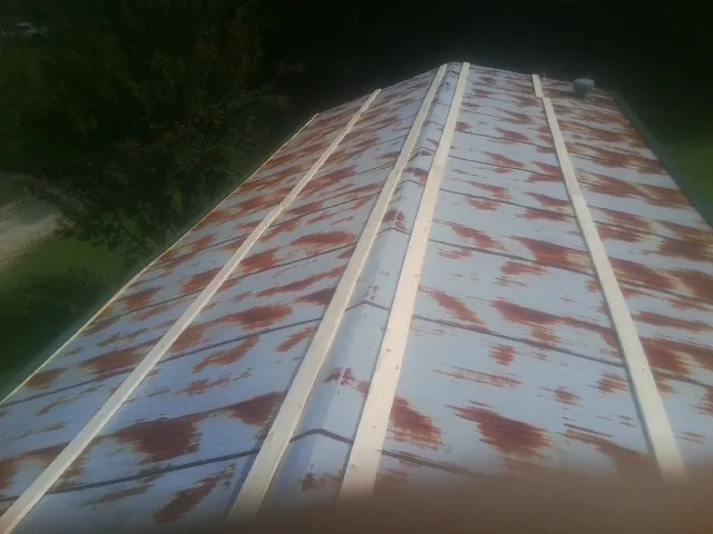 Rusted metal roof panels with new wood purlins before replacement — Storm Damage Roof Repair in Jupiter by Roofing Brothers